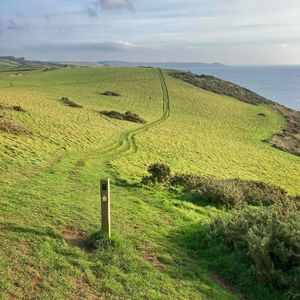 Scenic view of land and sea against sky