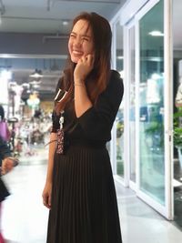 Smiling woman standing at shopping mall