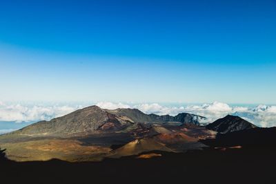 View of mountain range against blue sky