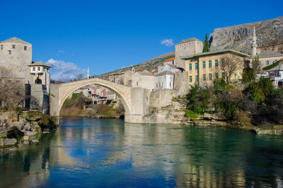 Bridge over river against blue sky