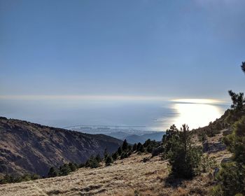 Scenic view of sea and mountains against sky