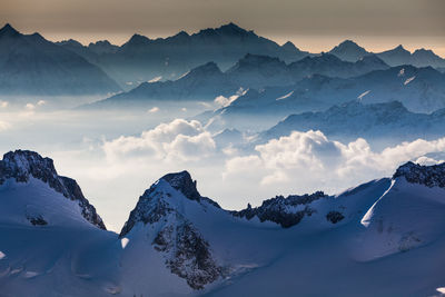 Scenic view of snowcapped mountains against sky during sunset