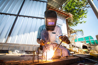 Welder at work in factory