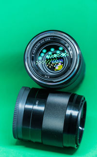 Close-up of camera lens on green background