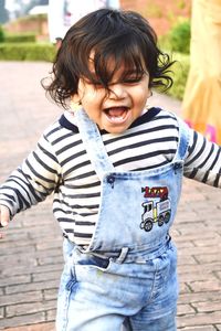 Toddler walking on footpath in city