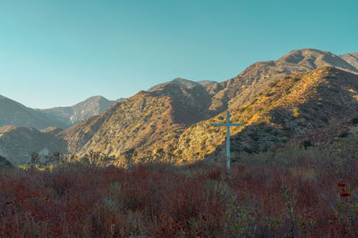 Scenic view of mountains against clear blue sky