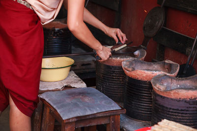 Midsection of man preparing food at market