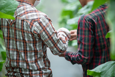 Rear view of couple holding hands