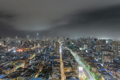 High angle view of illuminated city buildings at night