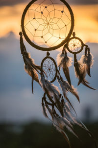 Close-up of dreamcatcher during sunset