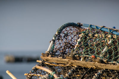 Close-up of fishing net on beach against clear sky