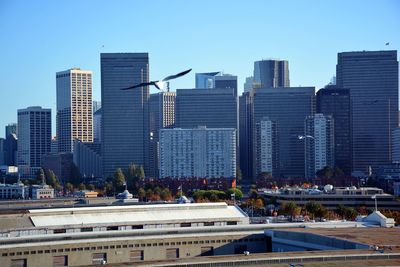 Skyscrapers in city against clear sky