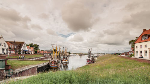 Boats on river against cloudy sky at werdum