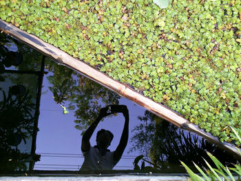 Man standing by tree