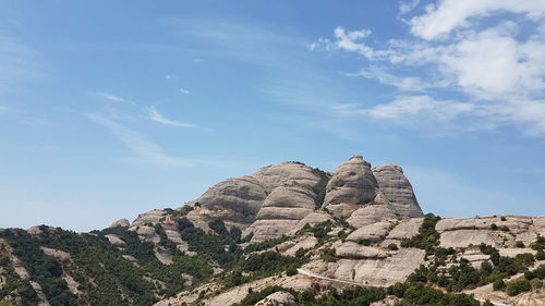 Low angle view of rocky mountains against sky