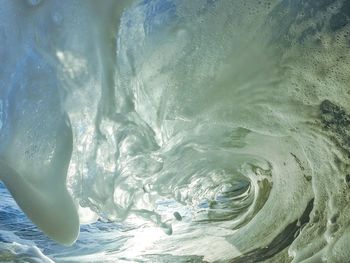 Close-up of water flowing against sky