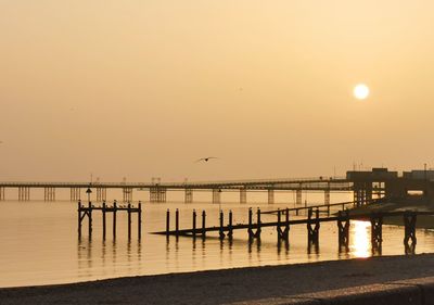 Silhouette pier on sea against sky during sunset