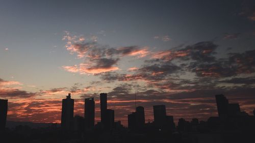 Silhouette of city at sunset