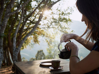 Woman drinking tea in garden