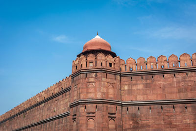 Low angle view of historic building against clear blue sky