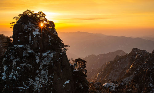 Scenic view of mountains against sky during sunset