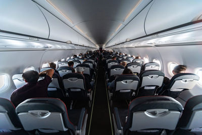 Rear view of people sitting in airplane