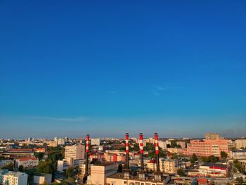 High angle view of buildings against blue sky