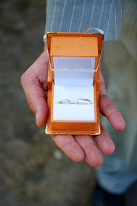 Close-up of hand holding paper outdoors