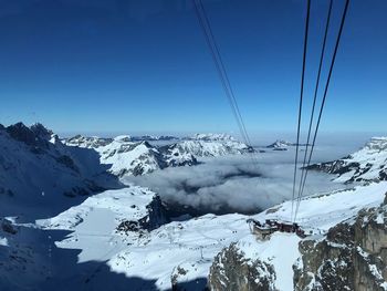 Scenic view of snowcapped mountains against clear sky