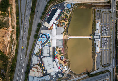 Aerial view of road by lake in city