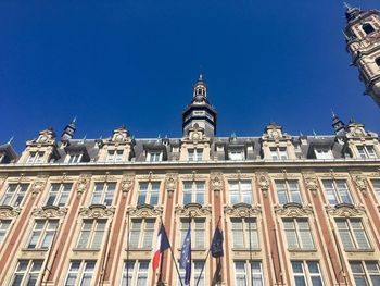 Low angle view of buildings against blue sky