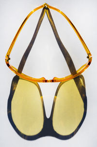 Close-up of sunglasses against white background