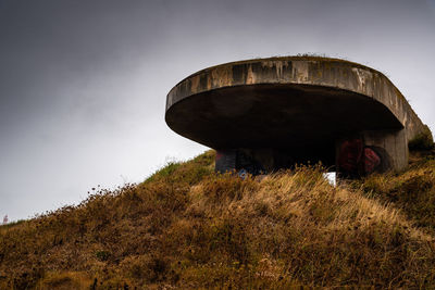 Low angle view of old abandoned building against sky