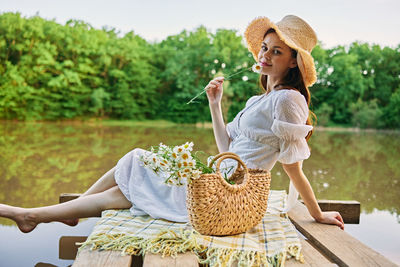 Young woman sitting on bench at park