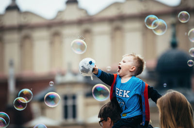 Close-up of boy playing bubbles