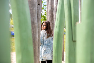 Woman standing against tree