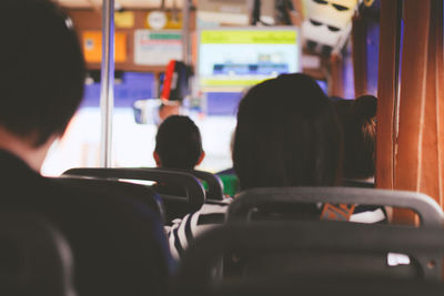 Rear view of people traveling in bus