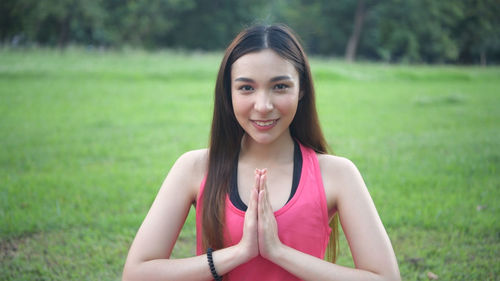 Portrait of smiling young woman on field