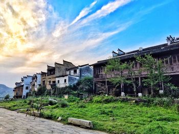 Houses against cloudy sky