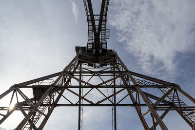 Low angle view of communications tower against sky