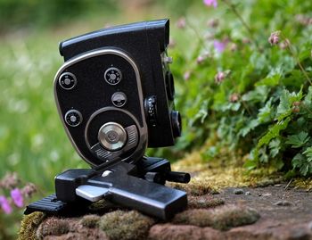 Close-up of antique camera against plants