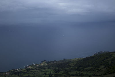 Scenic view of sea and mountains against sky