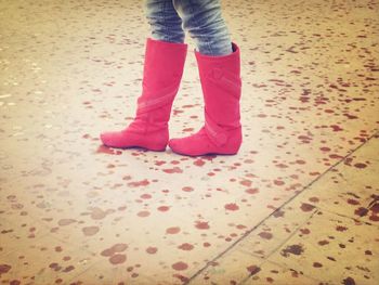 Low section of woman standing on tiled floor