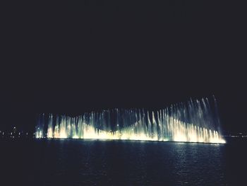 Scenic view of sea against clear sky at night