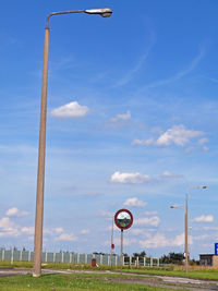 Street light against blue sky