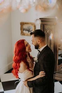 Wedding day. happy bride and groom hugging and laughing red hair diversity