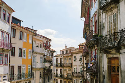 Low angle view of buildings in town against sky