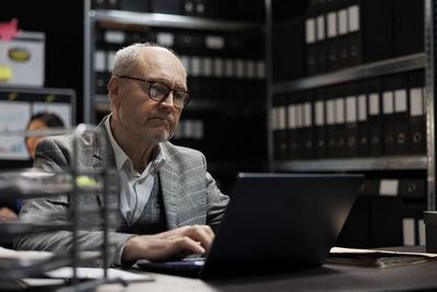 Young man using laptop at office