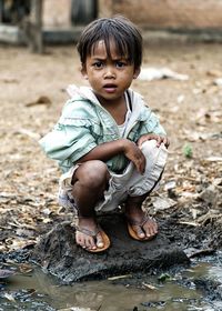 Portrait of cute boy in water