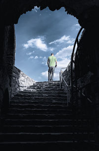 Heaven's door, rear view of man walking on the stairs